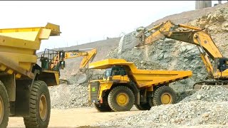 Loading giant zero kilometer dump trucks in iron ore mine