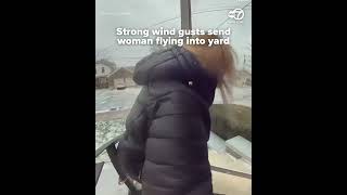 Strong wind gusts send woman flying into yard
