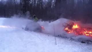 Dummy on snowmobile tries to jump big Bonfire.