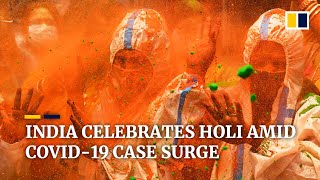 India celebrates colourful Holi festival as coronavirus cases in the country surge