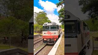 SCT locomotives speeding freight train through Exeter