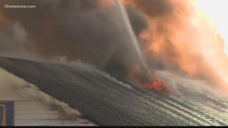 Flames tear through auto shop