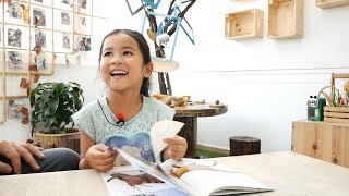 Reading at BEYC: A 4 year old girl demonstrates her love for independent reading.