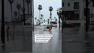 Man paddles through flooded San Diego street