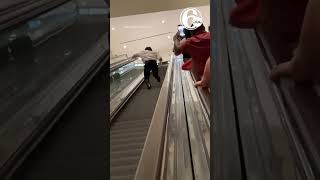 Man runs up lengthy downbound escalator as strangers cheer him on in Las Vegas, Nevada