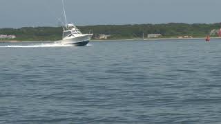 fishing boat speeding through bay waters