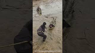 Use A Bamboo Pole To Pull A Woman Trapped In Silt Ashore