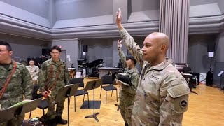 USARJ Band member teaches JGSDF members how to play the bugle