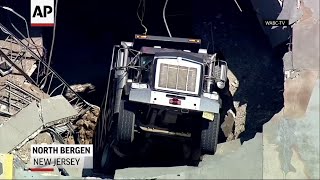 Truck falls through upper level of NJ garage