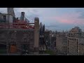 Ascending shot reveal a breathtaking sunset over the New York City skyline. Vibrant colors