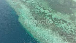 Aerial: Flying over tropical beach turquoise water coral reef , Tomia island Wak | Stock Footage...