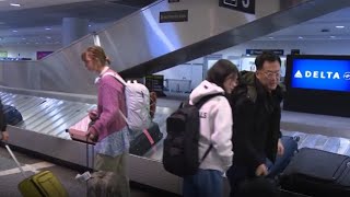 People escaping California wildfires arriving at Logan Airport