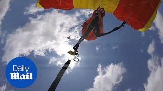 Skydiver forced to detach parachute as it tangles mid-flight - Daily Mail