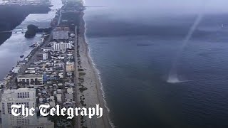 Waterspout crashes on to beach full of people in Miami, Florida