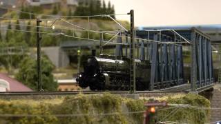 Märklin G5/5 [Item 39550] Bayerische Bulle pulling consist of Brawa passenger coaches over bridge