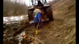 massey ferguson 3645 towing trailer of  mud