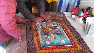 Silk brocading is a process of framing a Thangka in traditional Tibetan style