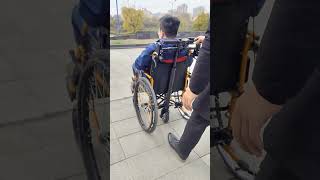 Back handbike for pushing wheelchair