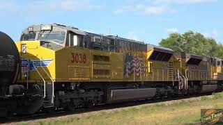 Grain train with a green CNW hopper and a mixed freight does a slow role by the campsite!