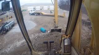 How to operate Cat 215 Excavator loading trucks from a bench