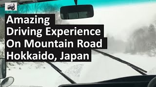 Beautiful snowing scene while driving on the mountain road to Nakayamatoge, Hokkaido, Japan