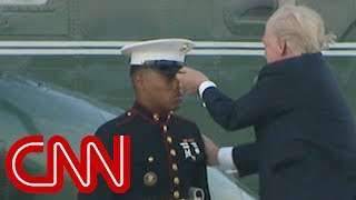 Trump lends hand to Marine whose hat blew away