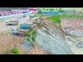 amazing bulldozer and dump trucks cooperate filling land into the big pond