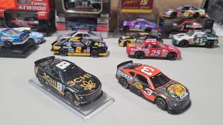 Why are some NASCAR 1:64-scale diecasts on a base?