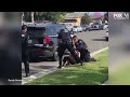 police officers stop fellow officer punching handcuffed woman during arrest