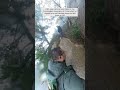 hiker slips and fall down rain soaked cliff. china hiker