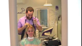 Young Woman Getting Her Hair Dressed in Salon