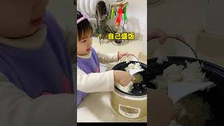 The 3-year-old cub holds a large bowl of rice by himself.