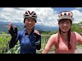 two girls dive into water while cycling