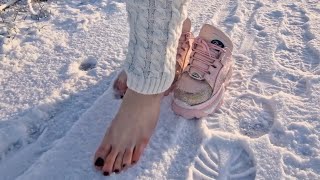 Slip off shoes to walk barefoot in the snow