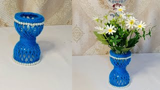 simple plastic and yarn flower vase