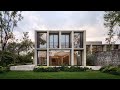 stone houses for two brothers on a steep site share a lush garden at the front it