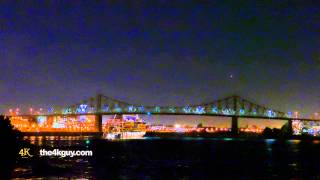 4K UHD - Luxury cruise ship lit up at night and navigating towards bridge