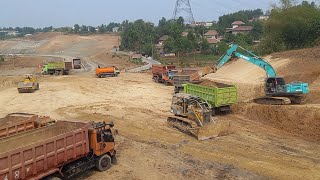 heavy equipment big project, single excavator kobelco sk200 loading soil into very  many truck