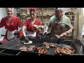 street food in bucharest romania. girls prepare sandwiches stuffed with sausage and meat