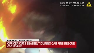 Officer cuts seatbelt during car fire rescue