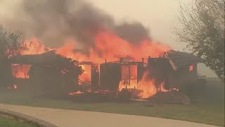 Wildfires burn out of control across Los Angeles area and kill 5 as thousands flee homes