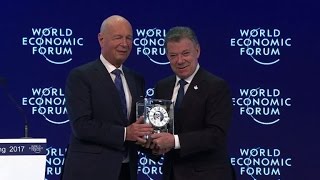 Colombia's President Santos receives award at Davos, talks peace