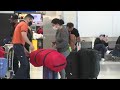 Air travelers at Miami International Airport react to CDC’s new coronavirus testing guidelines