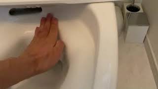 A man cleaning the toilet with his bare hands.