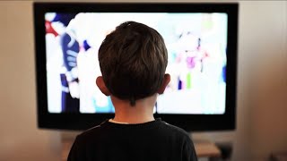 Children Snacking and Watching TV