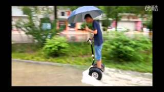 two off-road big wheel segway riding in the water