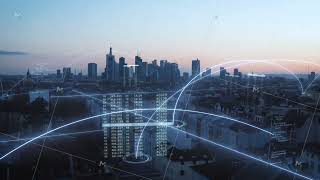 Digital lines connecting buildings in the Frankfurt skyline at sunset showcase data overlays, smart