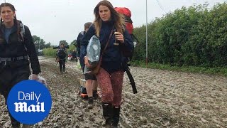 Glastonbury revellers trudge through mud as they arrive - Daily Mail