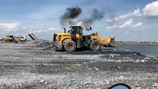 The SDLG Wheel loader and Kobelco SK260 Excavator Working On Construction Uploading By Dump Truck.