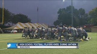 Madison high school football players kneel during National Anthem